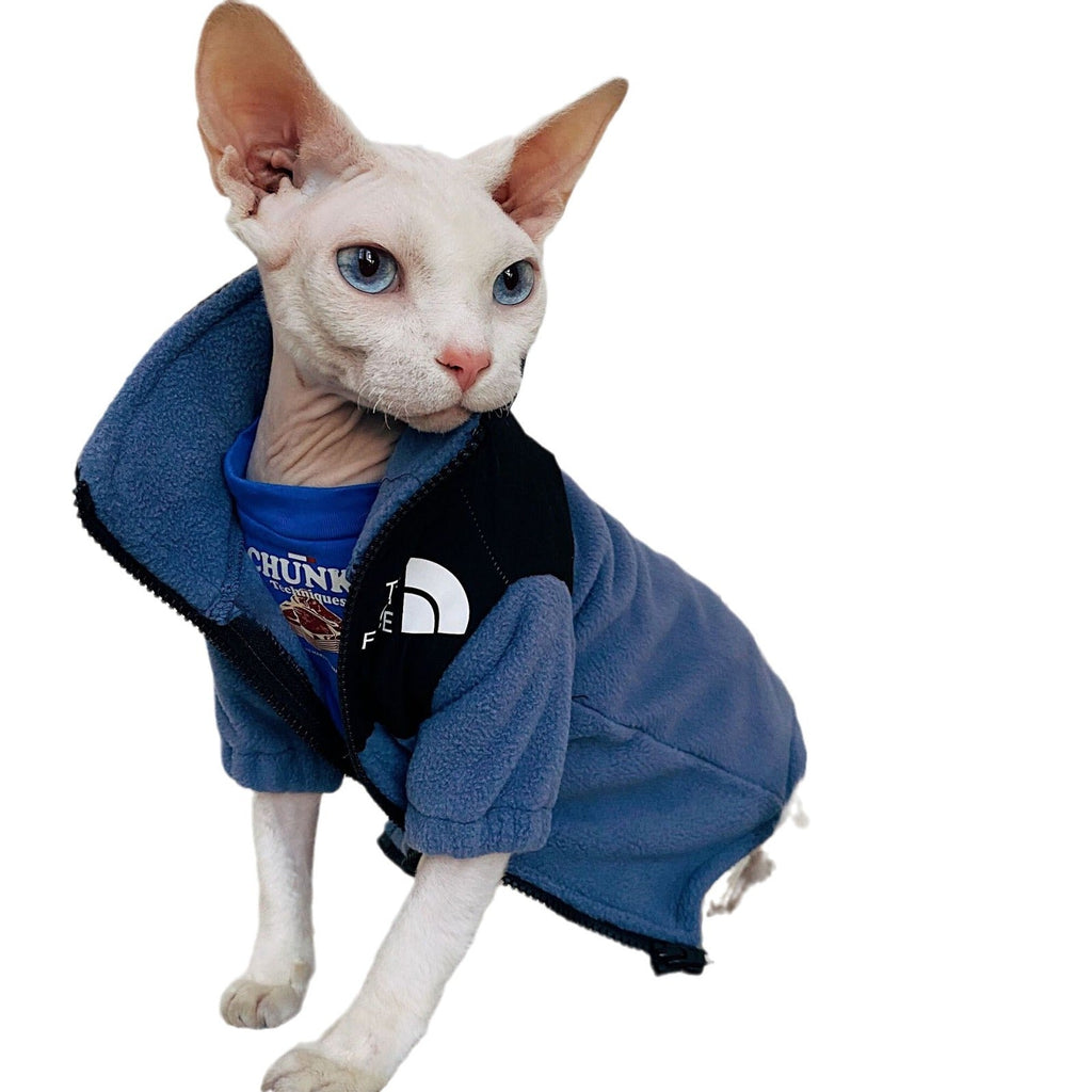 Blue fleece cat jacket with zipper and hood, dark trim and 'THE CAT FACE' chest patch.
