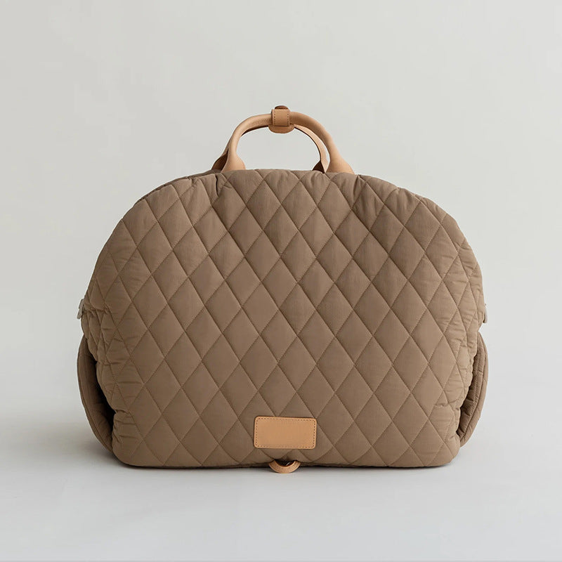 Khaki quilted pet handbag back view with top handle and tan patch