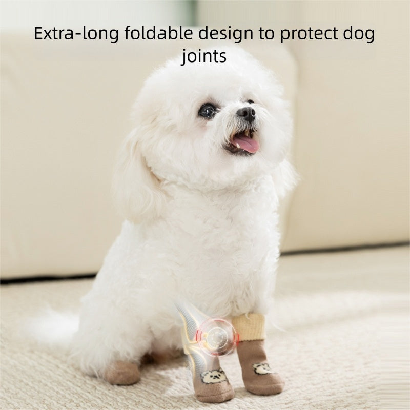 Small white dog wearing long tan knit socks with cartoon animal face patches