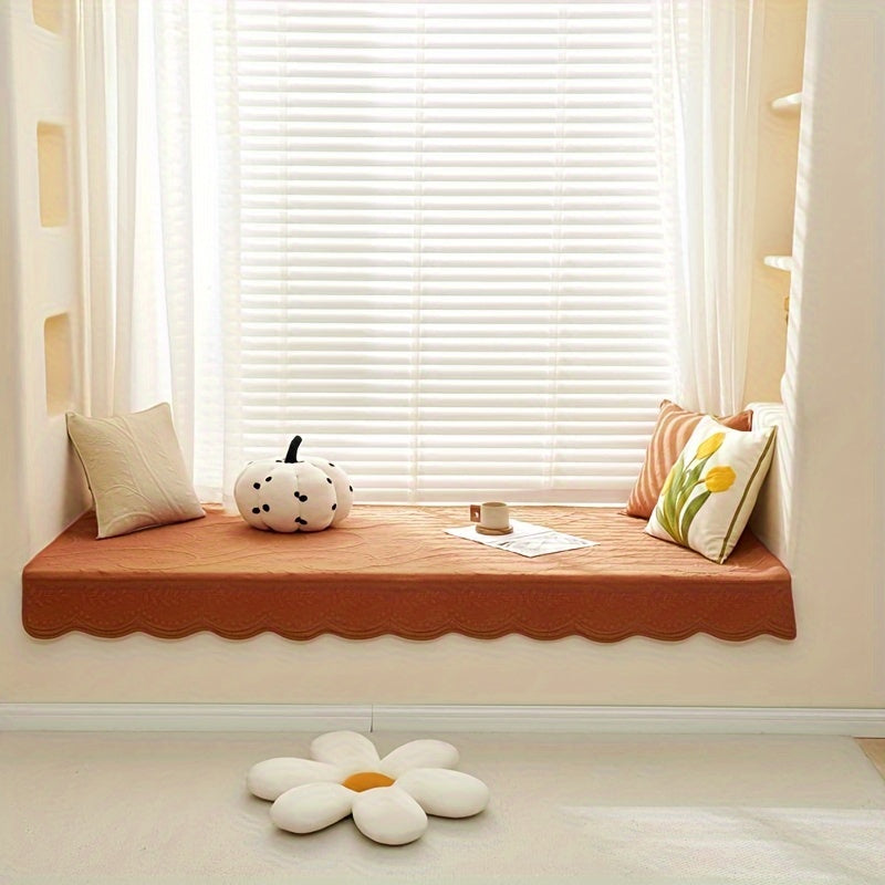 Orange waterproof sofa cover on window bench with scalloped lower edge