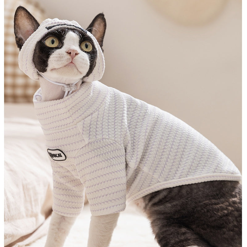 Cat wearing a white hooded two-legged pet base shirt with U C A T patch