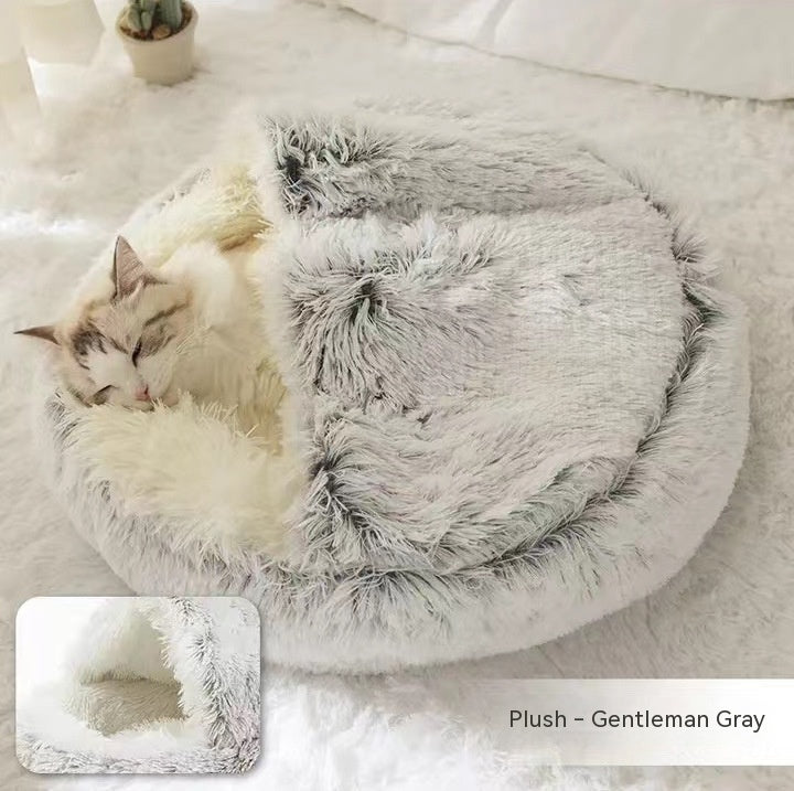 Round plush pet bed in light gray with shaggy exterior and front cave opening