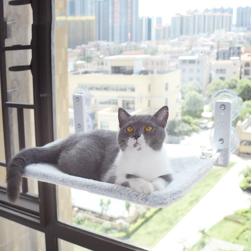 Grey cat hammock with suction cups, soft plush fabric on window glass perch