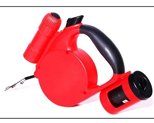 Red retractable dog leash with integrated waste bag dispenser and LED flashlight