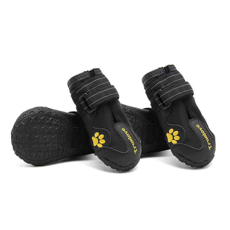 Black pet dog shoes with yellow paw emblem, hook-and-loop strap, textured non-slip sole