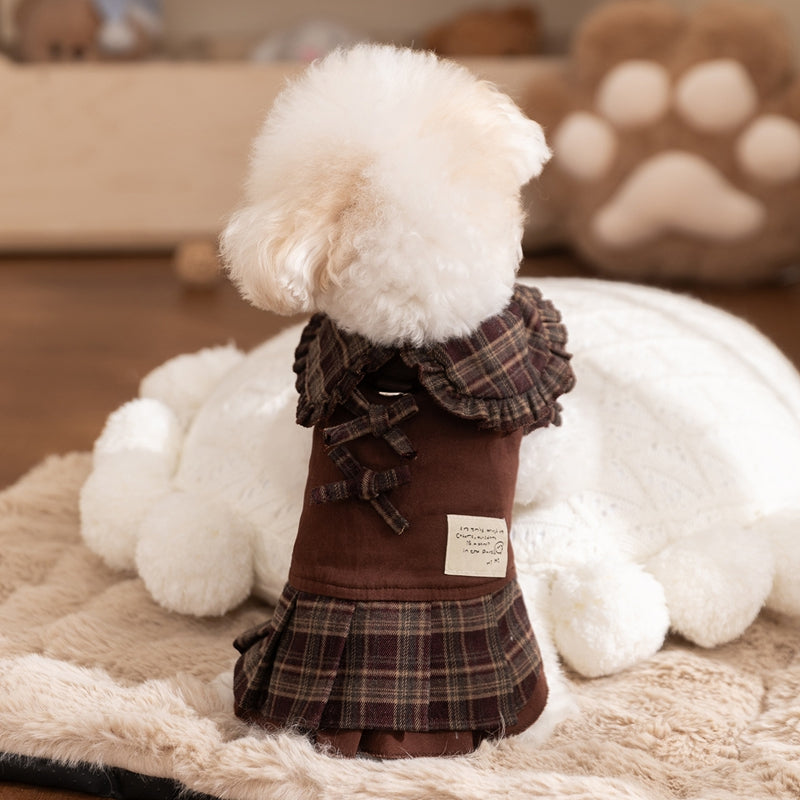 Back view of dog wearing brown plaid pet sweater dress with ruffle-trim skirt