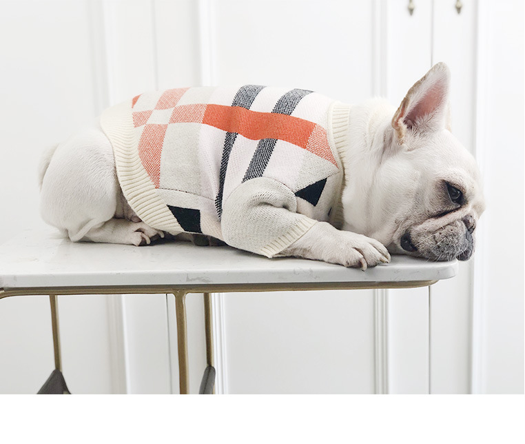 Dog sweater in cream knit with black and red plaid panels, ribbed cuffs and hem