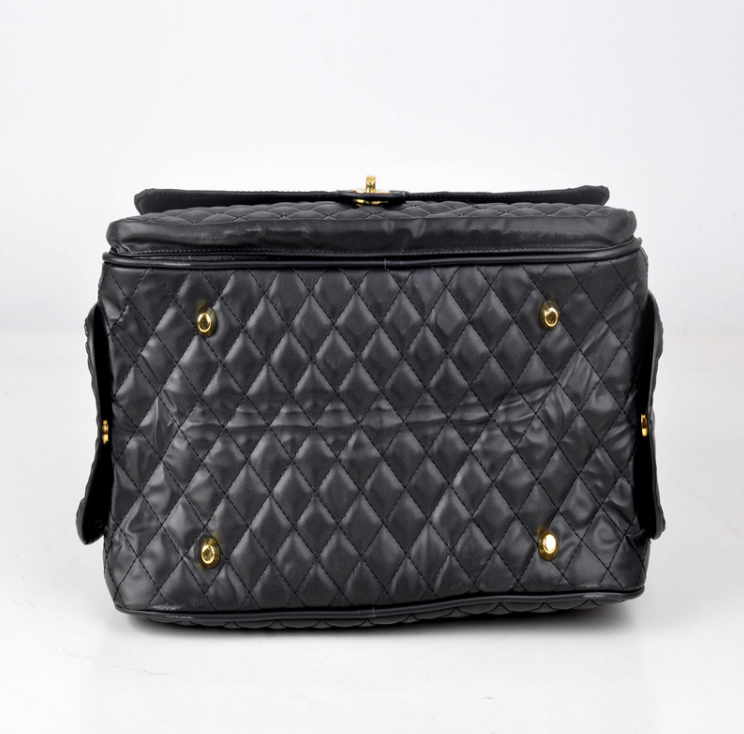 Black quilted pet duffel bag back view with snap tabs and gold rings