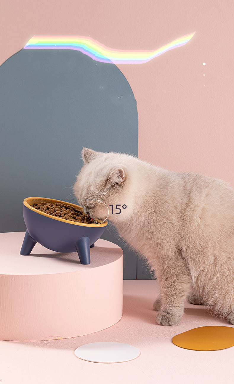 Elevated pet feeding bowl on three legs, dark blue outer with yellow inner bowl