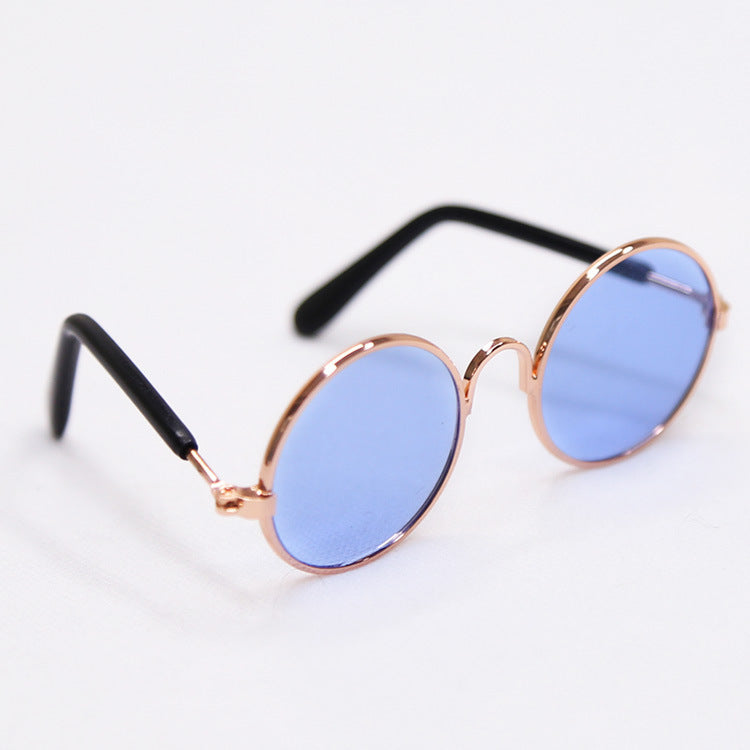 Round blue-tinted sunglasses with black temples and rose-gold frame