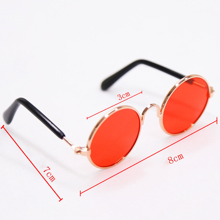 Round orange-tinted sunglasses with black temples and rose-gold frame