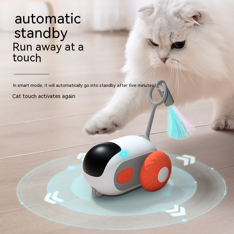 White automatic remote-control cat car toy on glowing pad with orange bumper and brush
