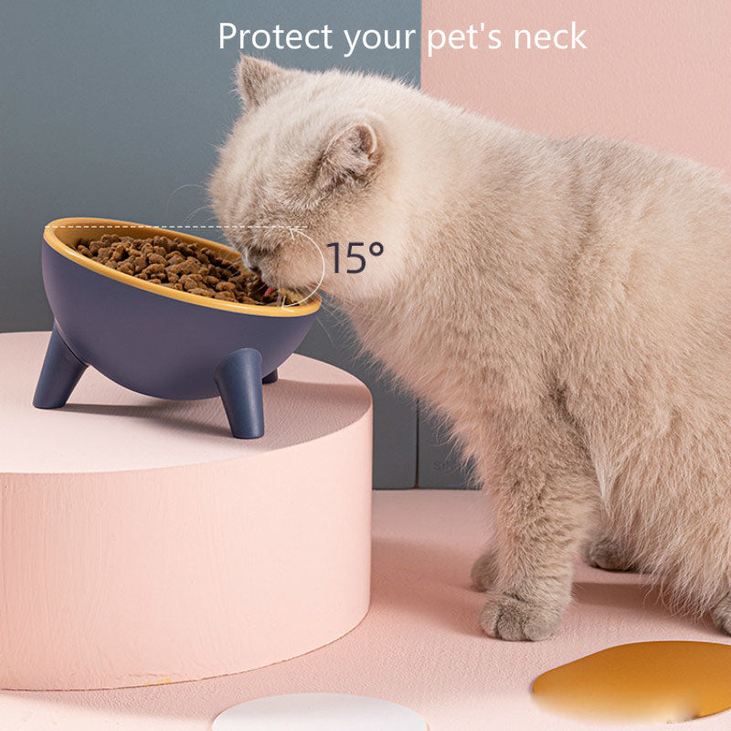 Elevated pet feeding bowl on three legs, dark blue outer with yellow inner bowl