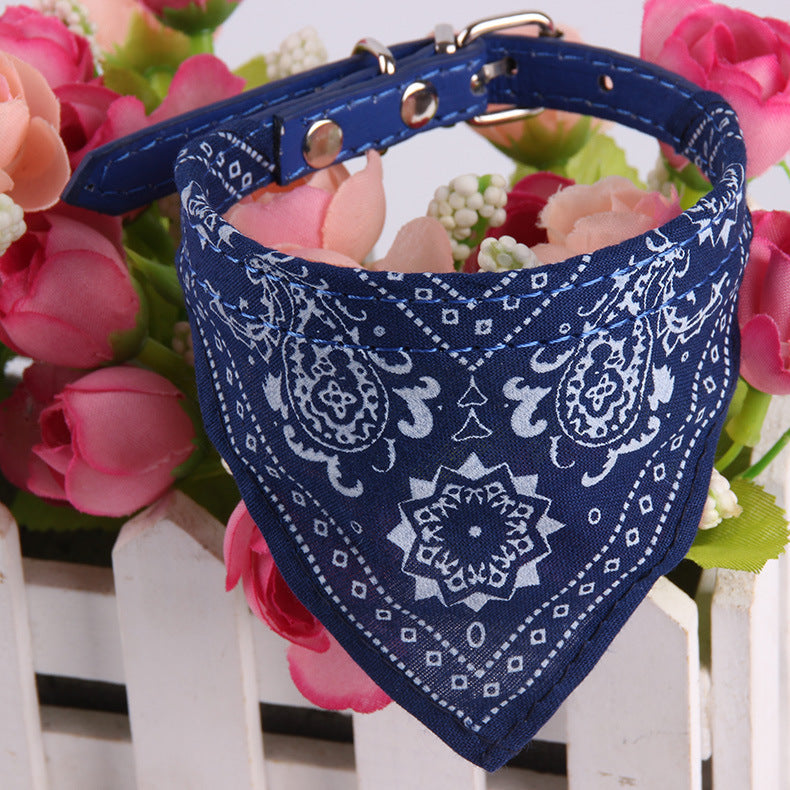 Blue pet bandana with white paisley pattern and metal buckle collar