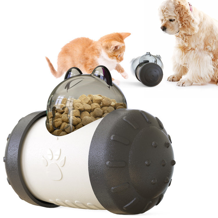 Interactive treat-dispensing wheel toy with clear top and dark gray-and-white ball body