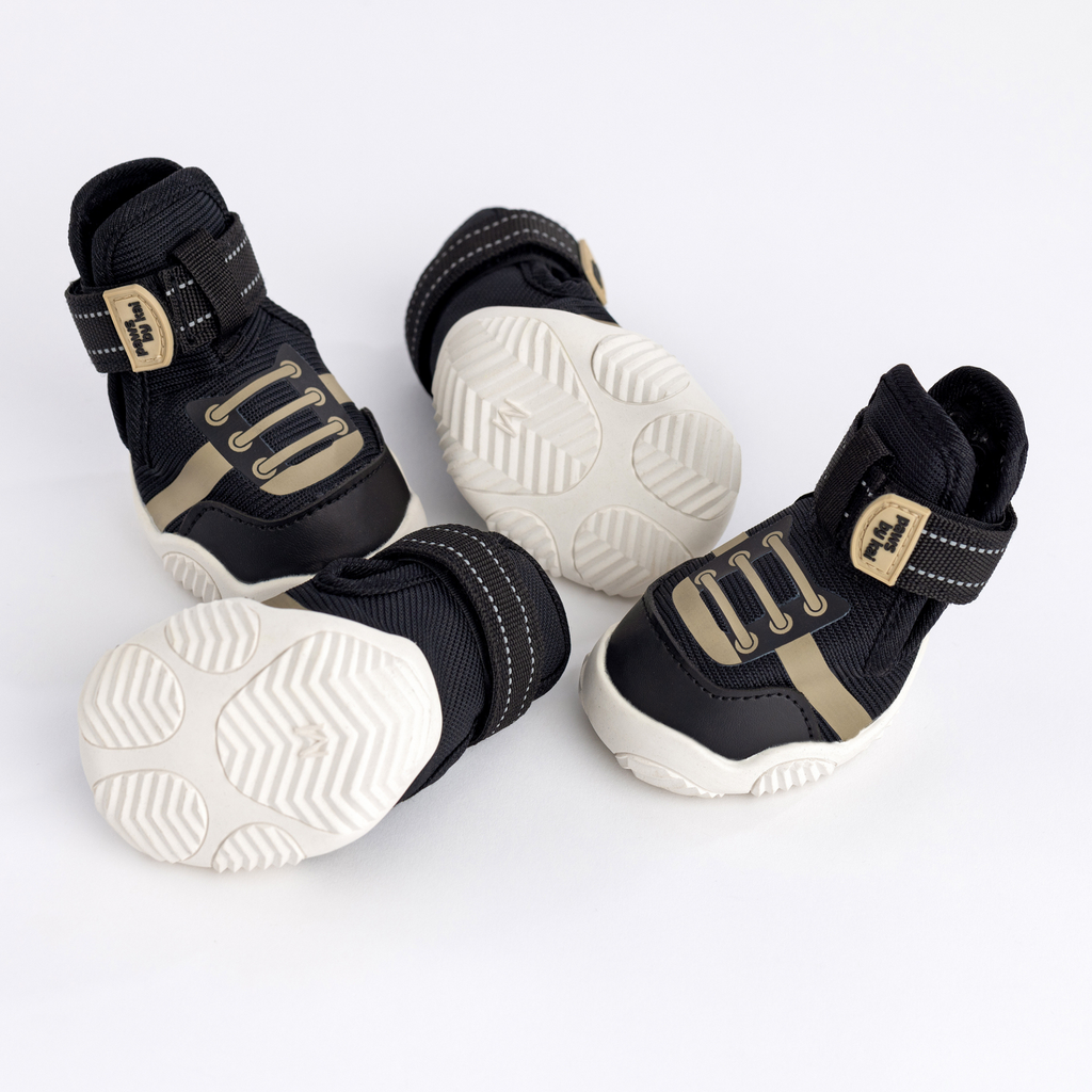 Kai- Dog sneakers in black showing treaded white outsole and Velcro straps