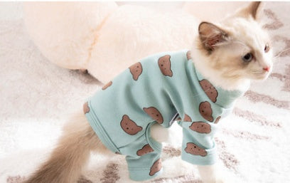 Light green cat onesie with brown printed shapes, four-legged design