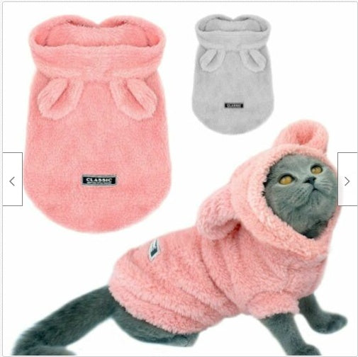 Pink and grey plush cat clothing: hooded pouch with bow, logo patch on front