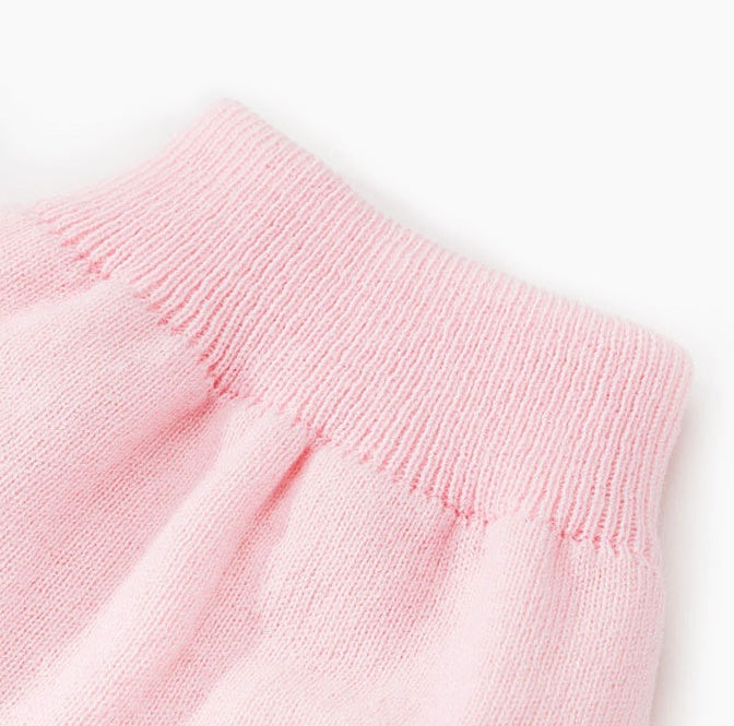 Light pink knit pet sweater close-up with ribbed neckline and shoulder seam