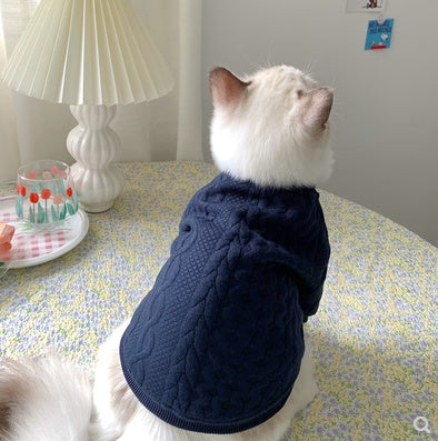 Navy pet jacket with quilted texture and gray bow, side view on white cat