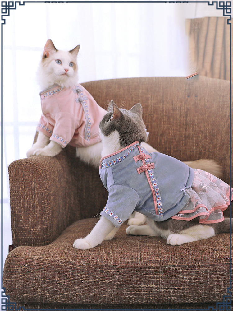 Pet cat clothes on cat, gray top with pink trim and patterned ruffled skirt
