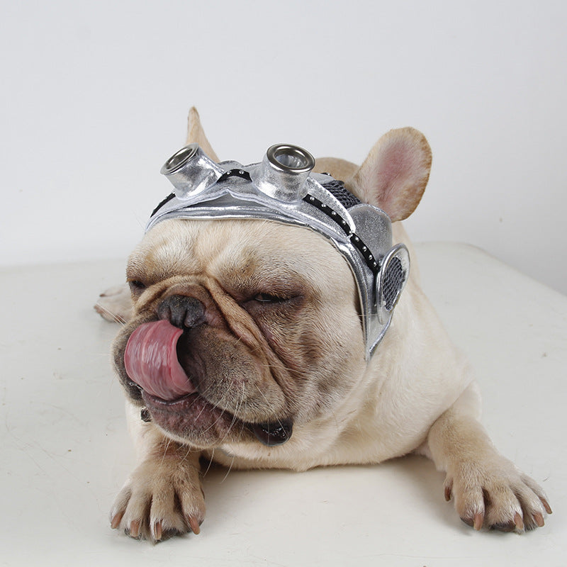 Dog party costume headpiece with silver metallic surface, black straps, and goggles