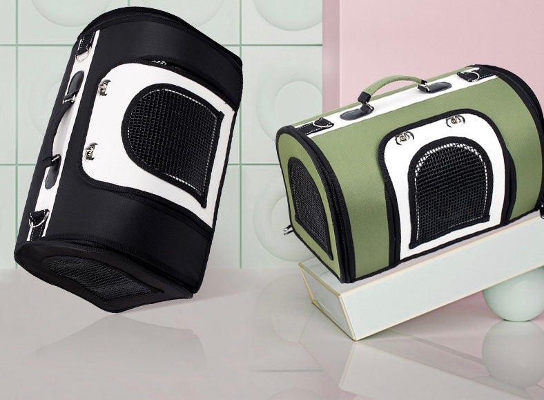 Black pet carrier handbag with mesh side door and white panel, top handle