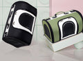 Black pet carrier handbag with mesh side door and white panel, top handle