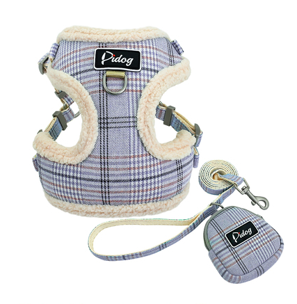 Plaid plush dog harness with label, matching leash and round pouch accessory, blue tones.