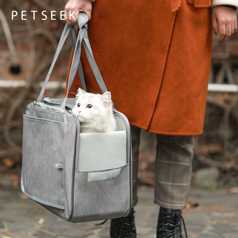 Gray pet backpack carrier tote with front pocket and mesh window, holding a white cat