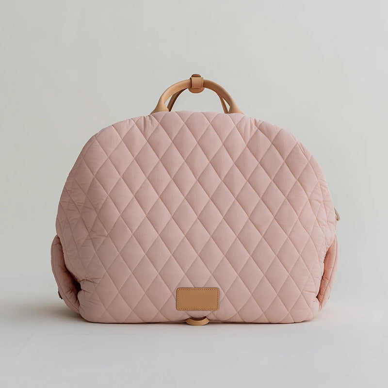 Pink quilted pet handbag with top handle and tan front patch
