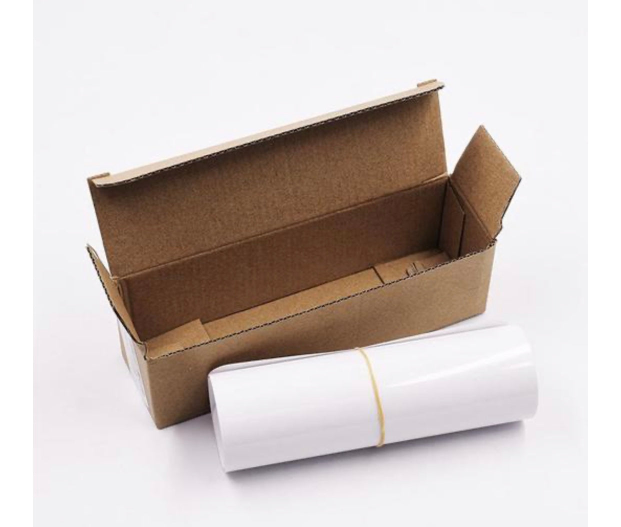 Cat scratching furniture guard roll with white cover in open brown carton