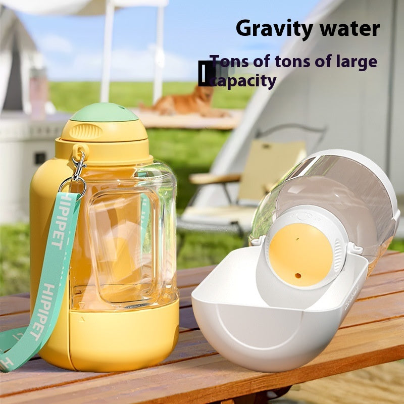 Yellow-and-clear pet gravity water dispenser with white integrated drinking bowl