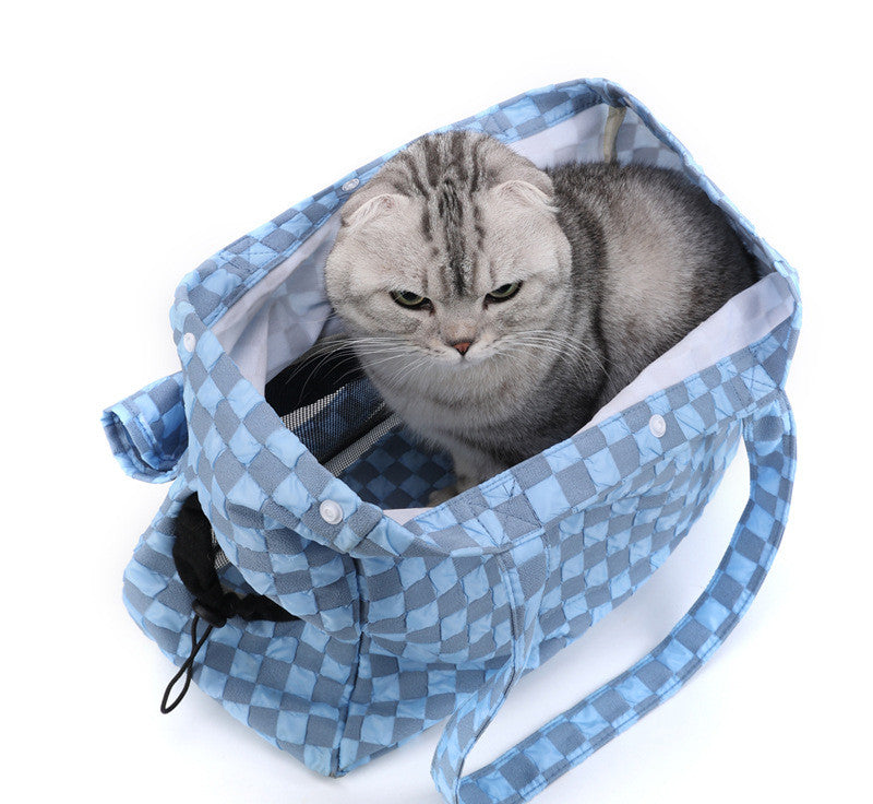 Blue check small cat shoulder bag with opening, holding a cat inside.