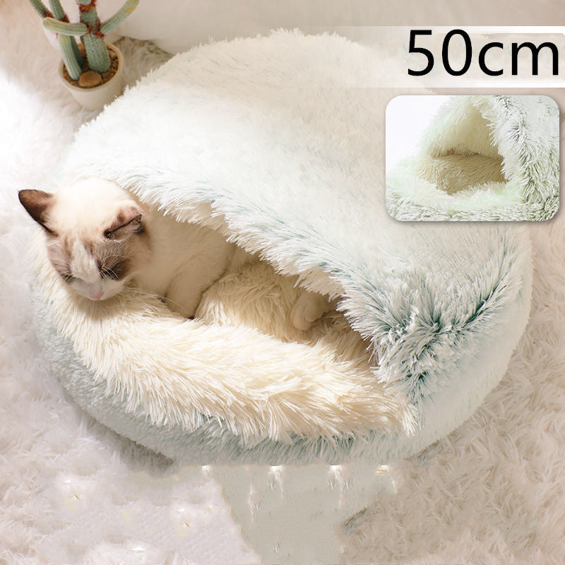 Light blue-green round plush pet bed with cozy inner nest for cats and dogs, pet lying.