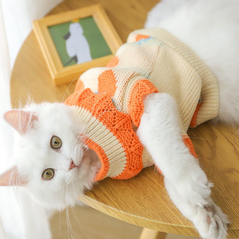 Cat sweater, cream knit with orange trim and blue-and-orange heart pattern