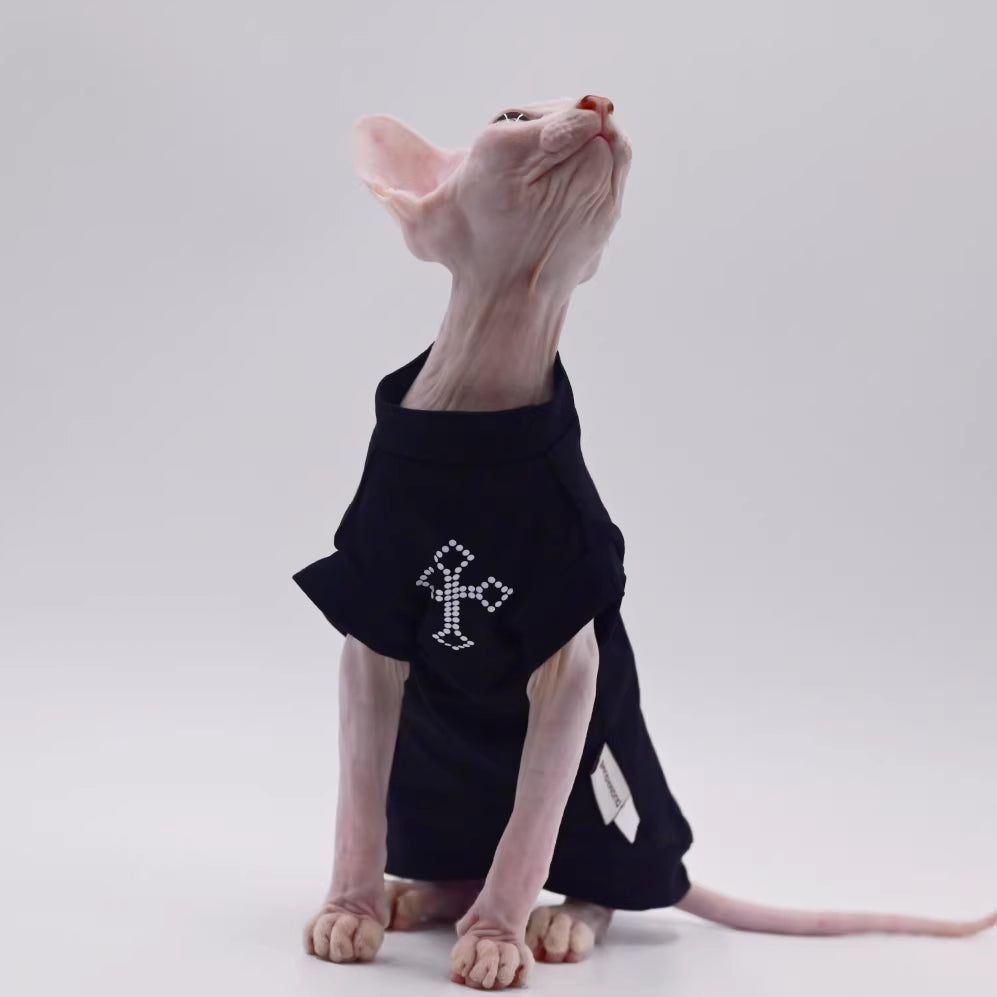 Black cat vest with cross rhinestone-style logo, side view with label tag