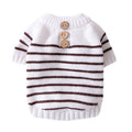 White dog knit sweater with brown-striped bands and three wood buttons at neck