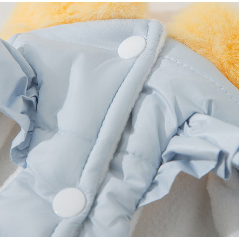Light blue puffer pet jacket close-up with snap button and seam lines