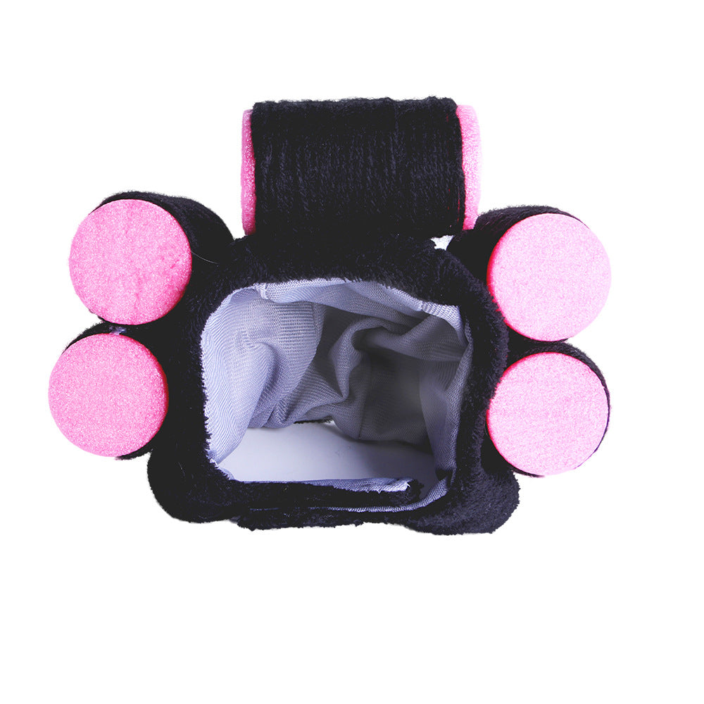 Black pet hat with pink pom-poms and blue inner fabric, front opening visible
