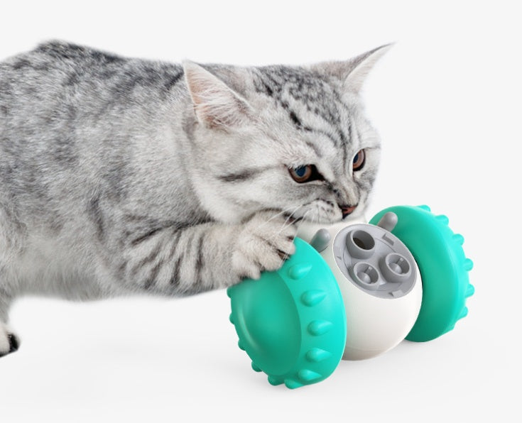 Teal-and-white slow-feed balance pet toy car with clear food window and spiked sides