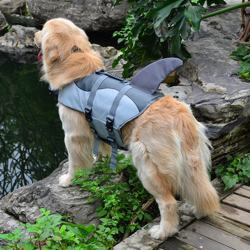 Light gray and blue dog life vest with shark fin top, adjustable straps