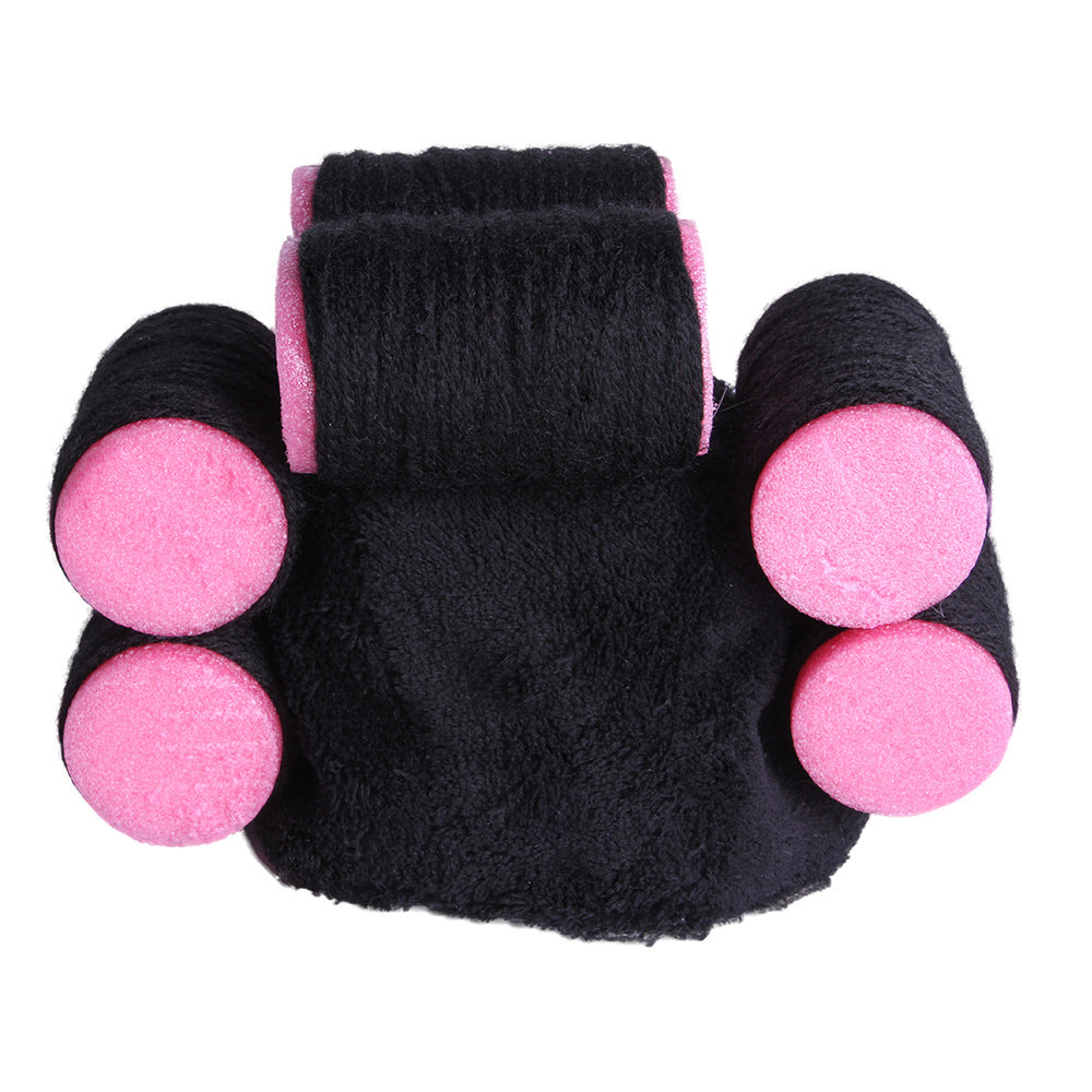 Black pet hat with four pink pom-poms and a pink-edged top center panel