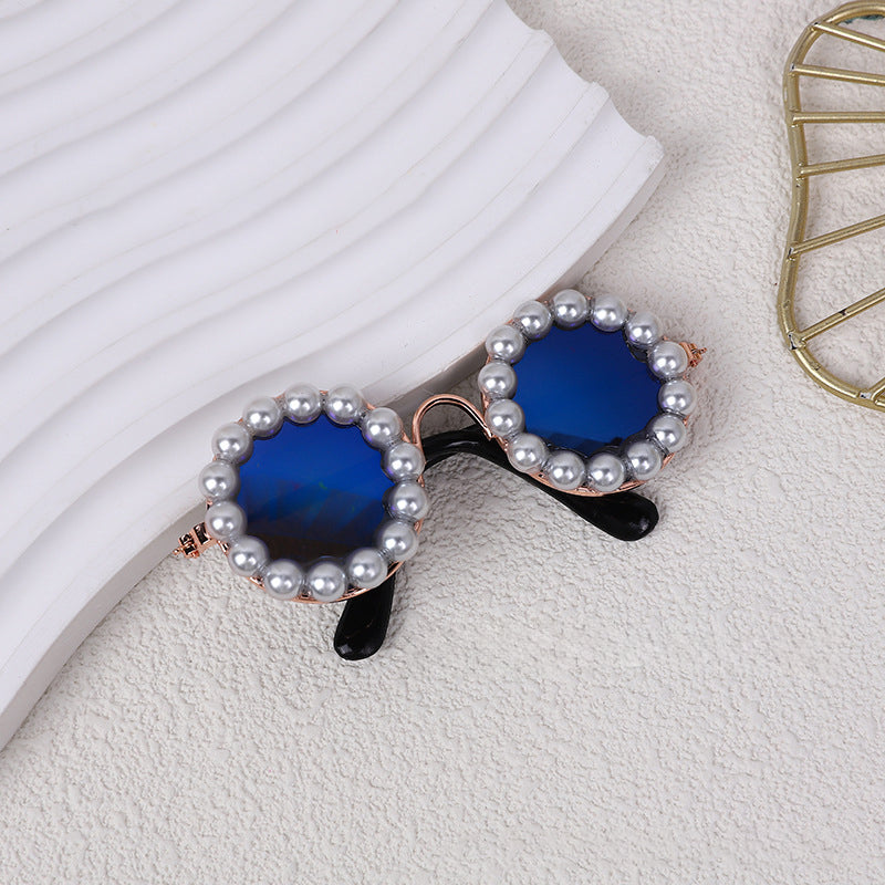Round pearl sunglasses accessory with blue lenses and black arms