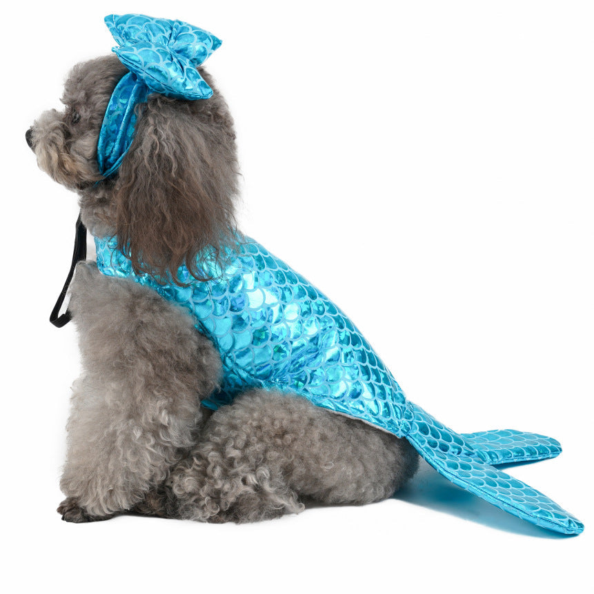 Small dog in a blue mermaid pet costume with tail fin and bow headpiece, side view