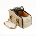 Beige portable pet car bed with black trim, mesh window and shoulder strap