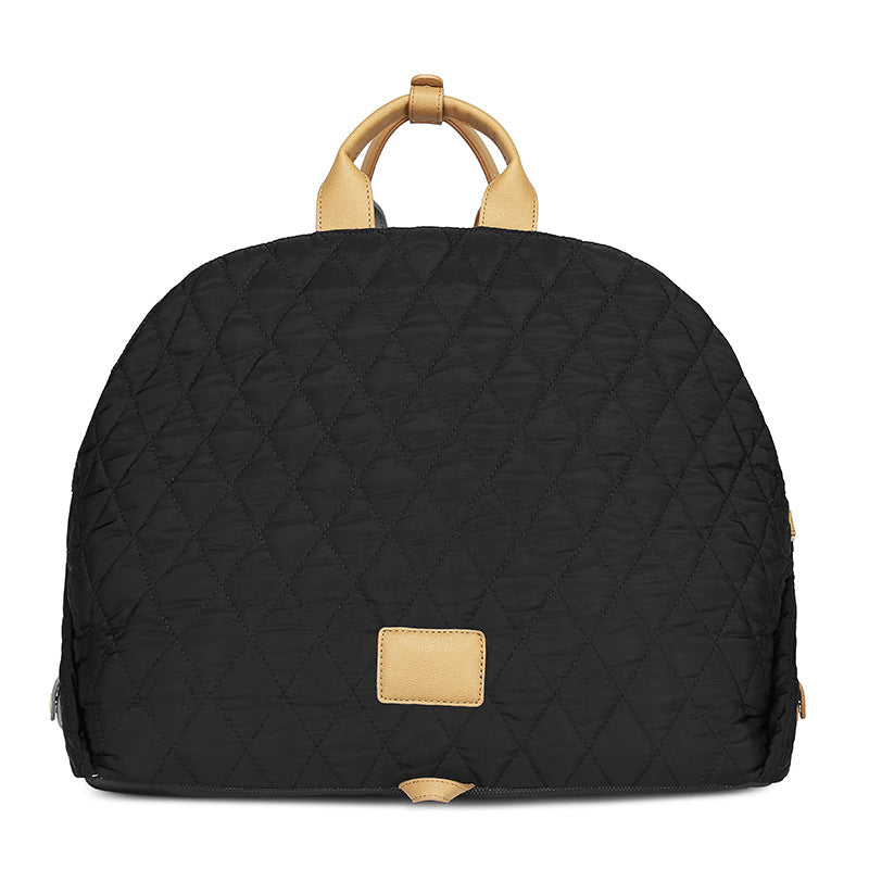 Black quilted pet handbag with top handle and tan front patch