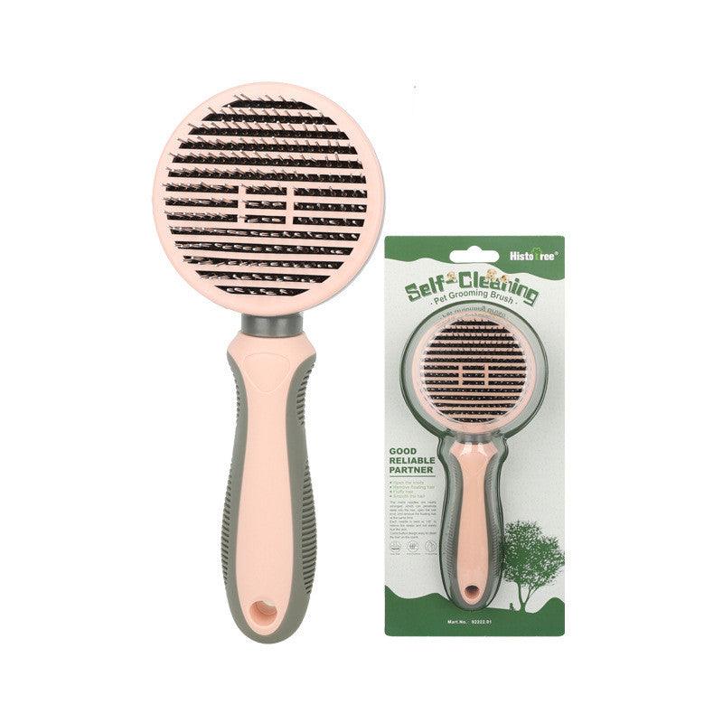 Pink pet grooming brush with dense needle rows on round head and ergonomic handle