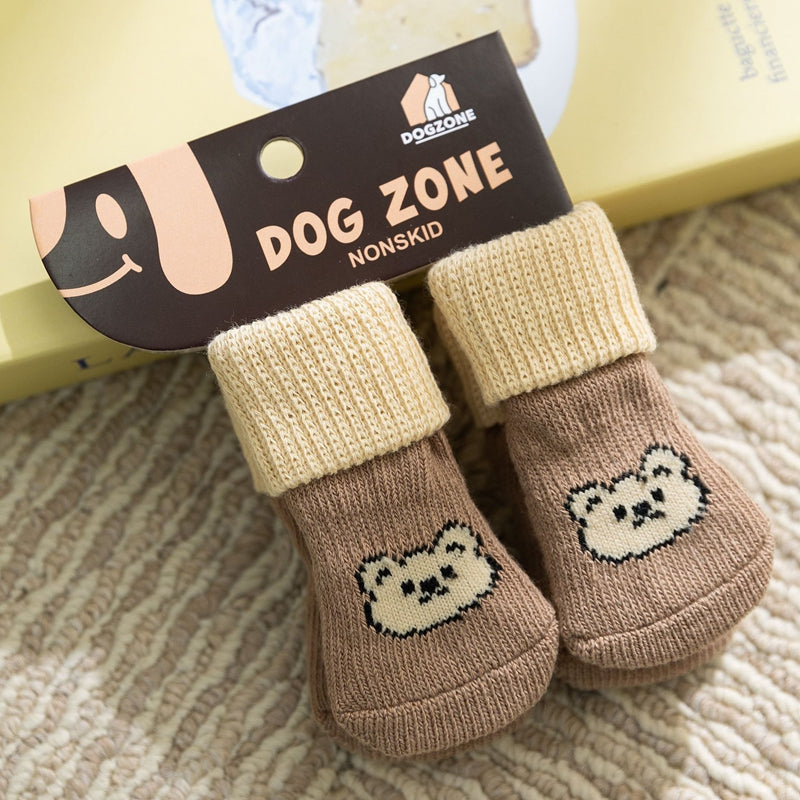 Beige and brown dog socks with a white bear face knit patch on the toe