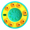 Slow feeding puzzle dog bowl with teal center and orange treat cups on yellow base